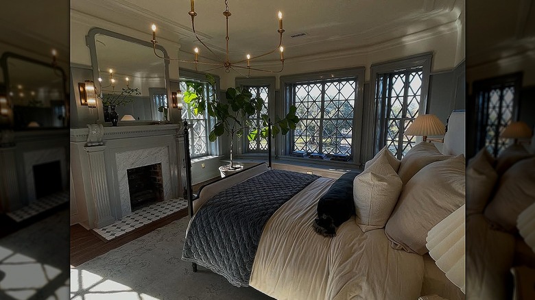 A view of the Castle's primary bedroom, with a fireplace that has checkered floor tile in front