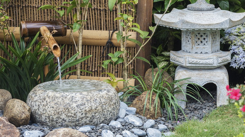 stone fountain with a bamboo spout