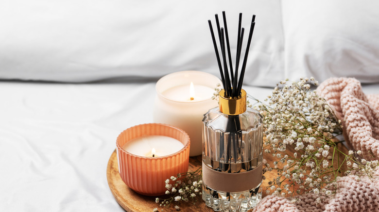 candles and diffuser in bed