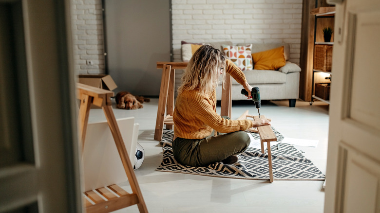 woman drilling wood for diy project