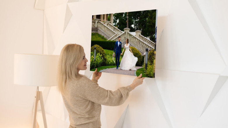 Person hanging wedding photo