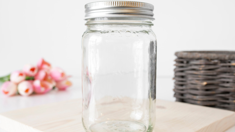 Empty Mason jar on wood board