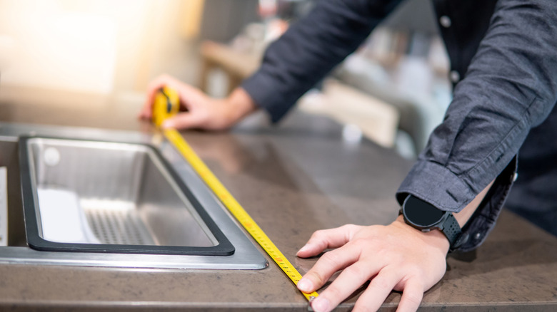 Person measuring sink