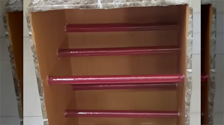 Shelves made with rods and cardboard box