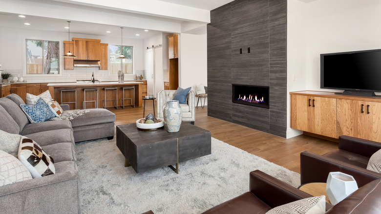 living room with matching furniture with kitchen