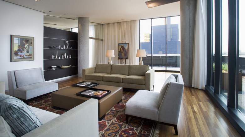 Overcrowded living room with four sofas