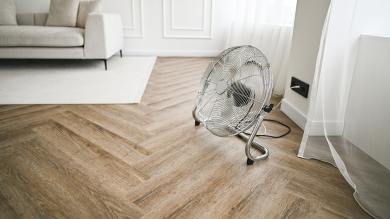 A floor fan working in a living room