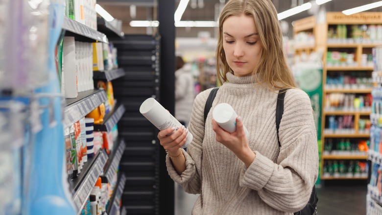 woman looking at shampoo