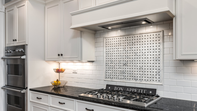 A kitchen with a under cabinet hood