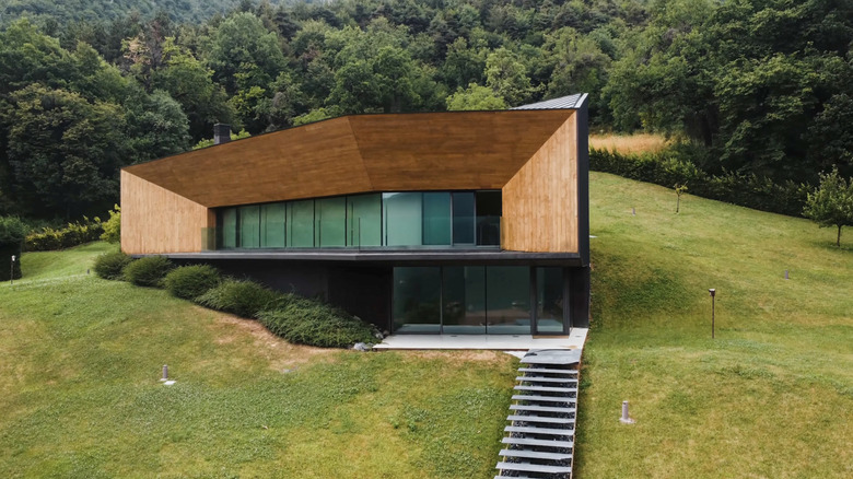 Modern bermed house with forest in the background