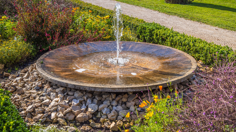 A plate fountain with a single spout of water