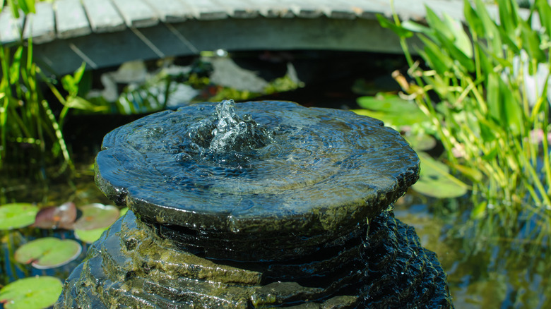 Closeup of a bubbling urn in a fish pond