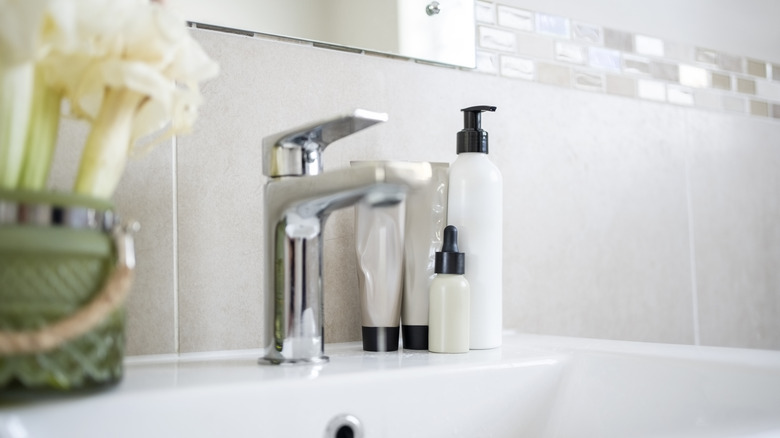 Bathroom counter with a few beauty products by the sink