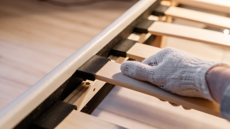 person assembling bed frame