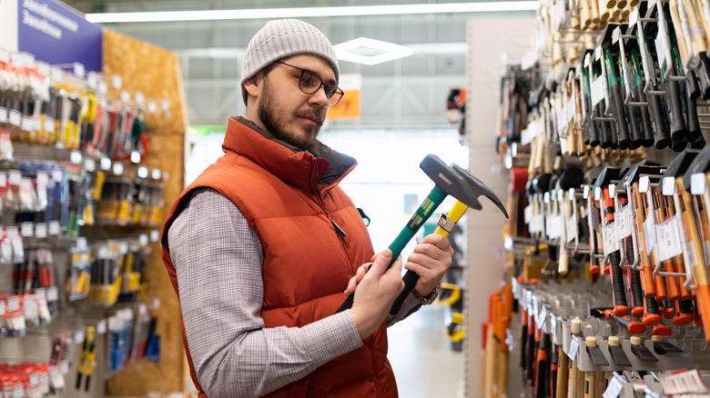 Man shopping for hammers