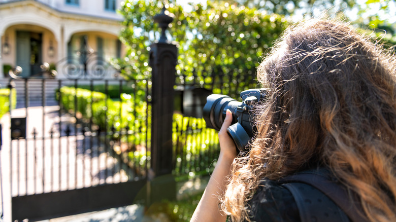 Photographer taking photo of house 