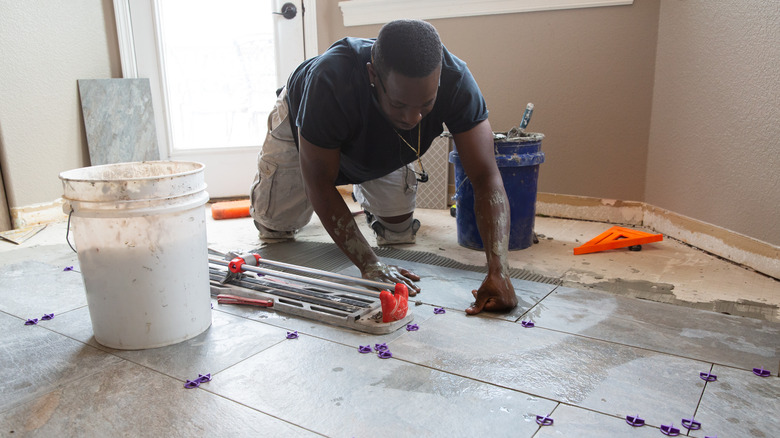 Man installing tile floors