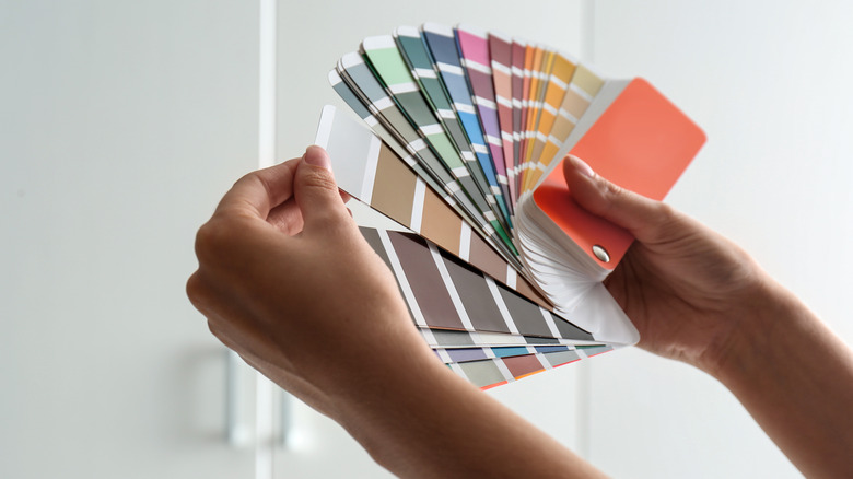 hands holding paint color palette