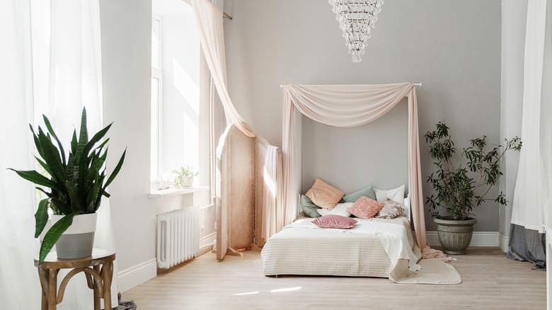 Bed with pink curtain headboard