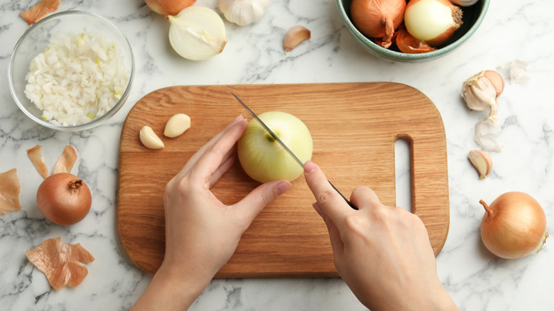 person cutting onion