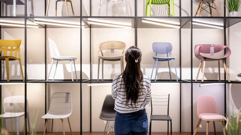 Person looking at chair display in showroom.
