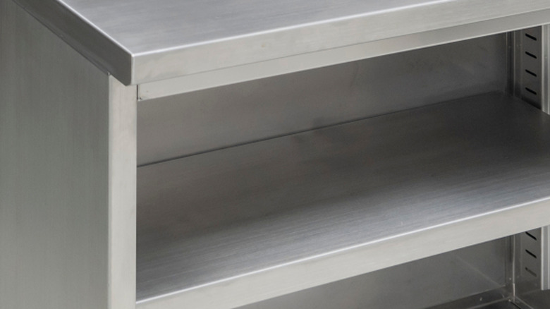 A closeup of a chrome table with shelves.