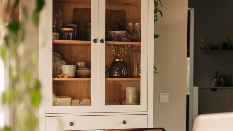 Free-standing kitchen cabinet with glass doors