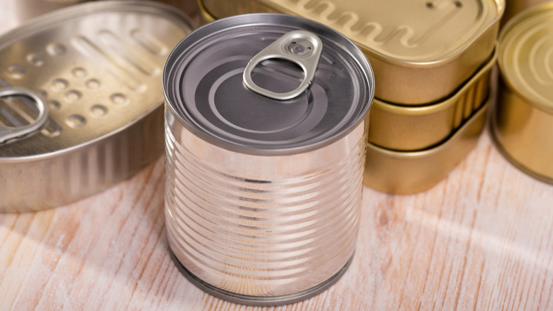 Metal tin can on surface unopened without label