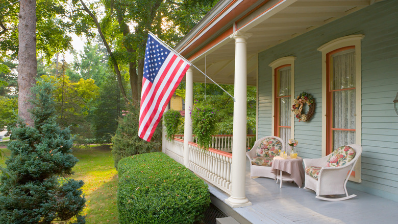 Front porch with rockers, American flag