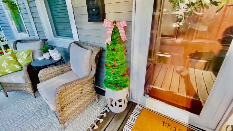 Christmas tree, made of garland wound around a tomato cage and including lights.
