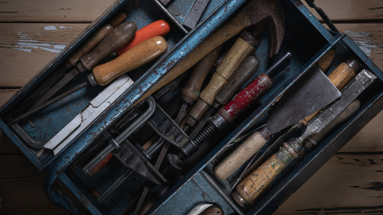A vintage toolbox on a wooden table