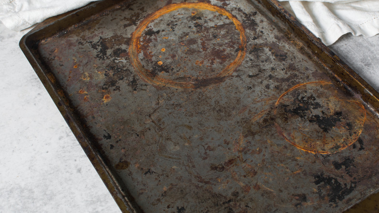 An old cookie sheet with rings on it