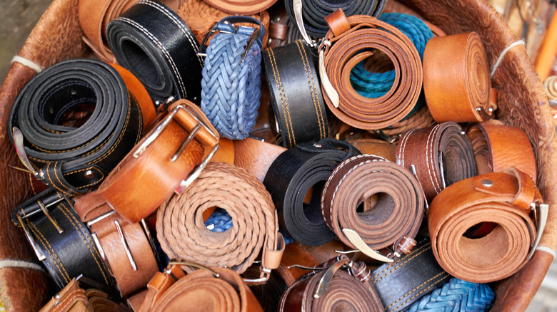 Rolled leather belts in a basket
