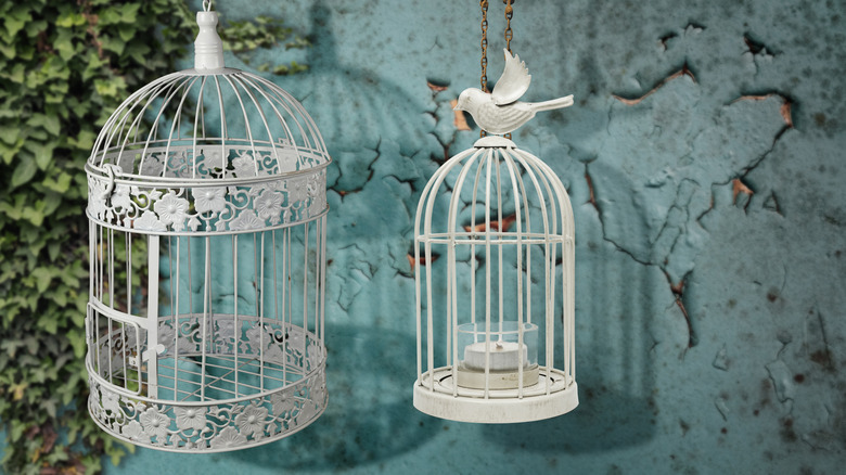 Two white bird cages 