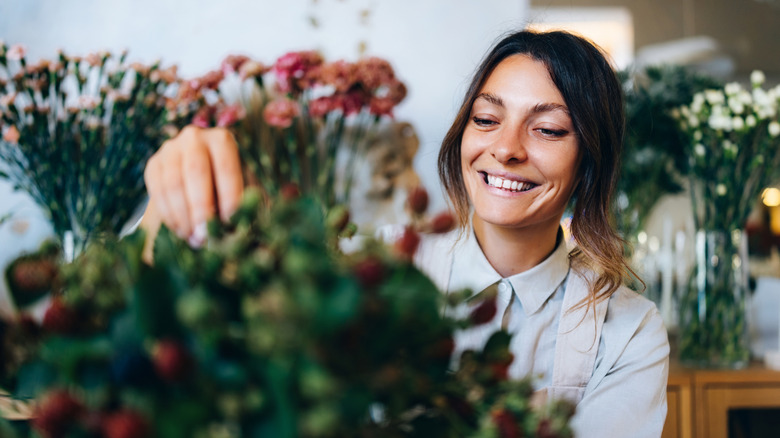 Someone picking out flowers from a boutique.