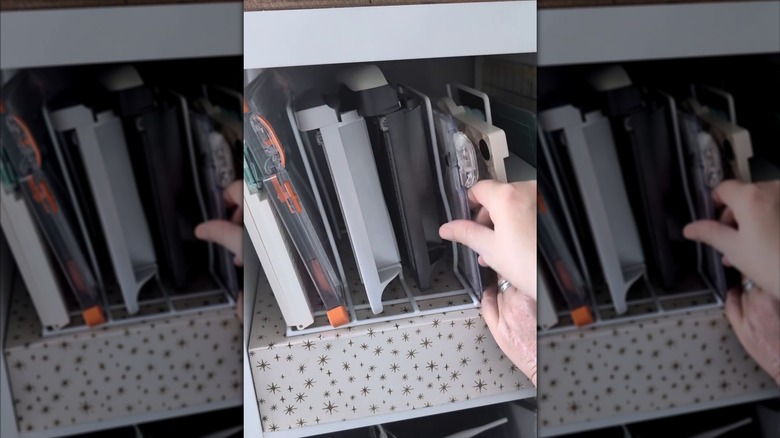 Paper trimmers and crafting tools on a pot lid organizer