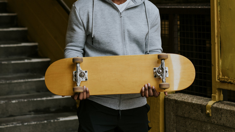 Someone holding a skateboard
