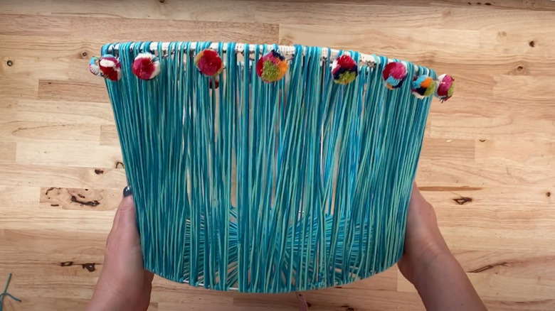 DIY woven basket from tomato cage and blue yarn