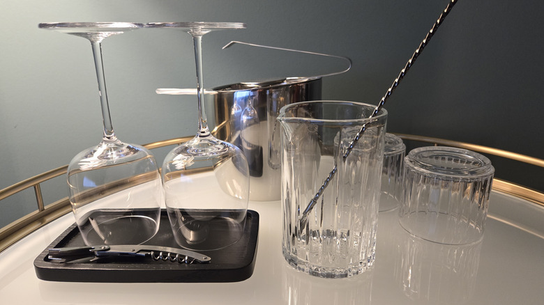 A bar cart with glasses and an ice bucket