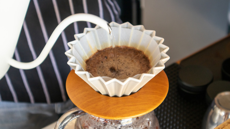 hot water being poured into coffee filter to make coffee