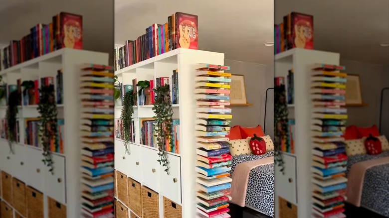 A DIY floating bookshelf using IKEA plate holders mounted on the wall of a shelving unit