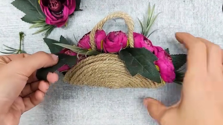 DIY flower basket made of metal lid covered with twine rope