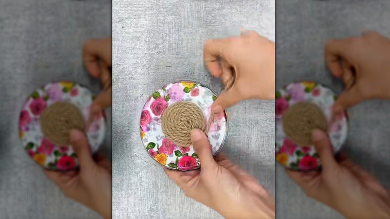 Person gluing twine to a metal jar lid