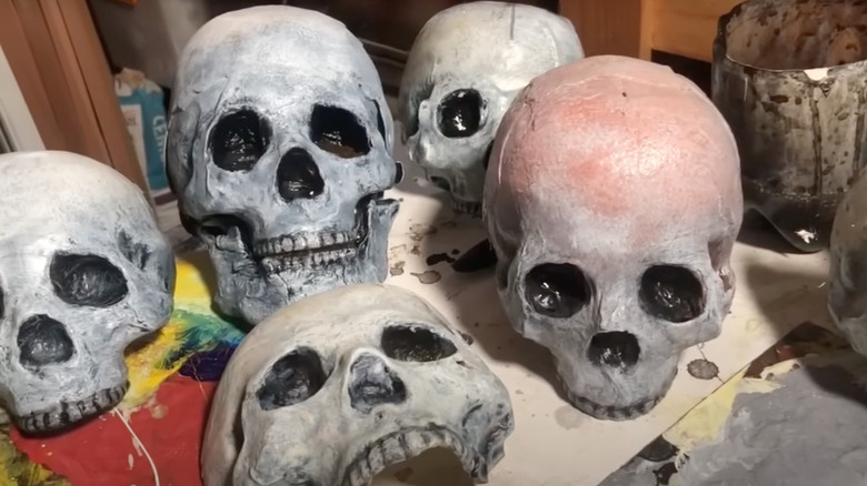 Milk jug skulls painted in different colors to resemble old bone