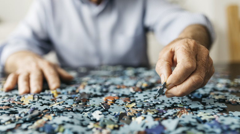 person doing a jigsaw puzzle