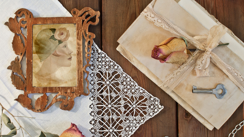 picture frame and doily on a table