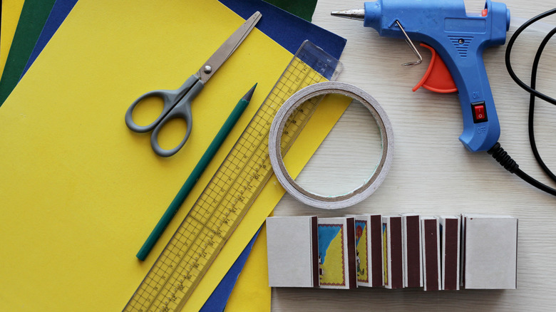 Scissors, construction paper, and matchboxes ready for a project.