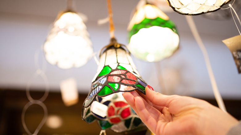 Person shopping for a glass lampshade