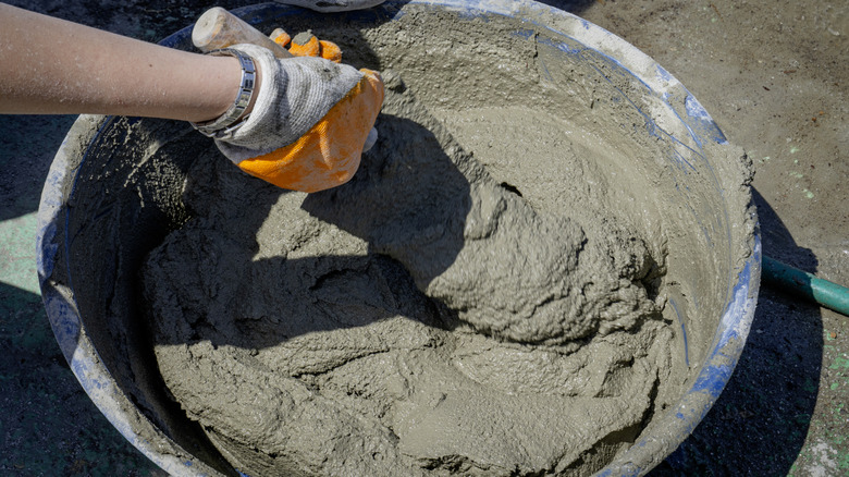 Woman mixing concrete.