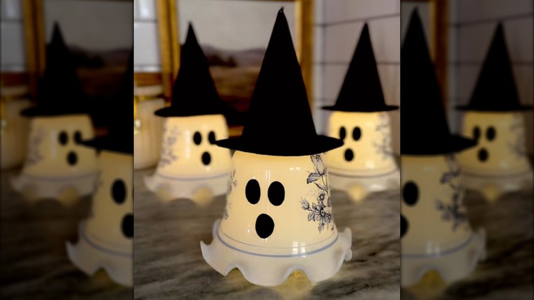 Three ghost decorations are made from felt and old glass lampshades.